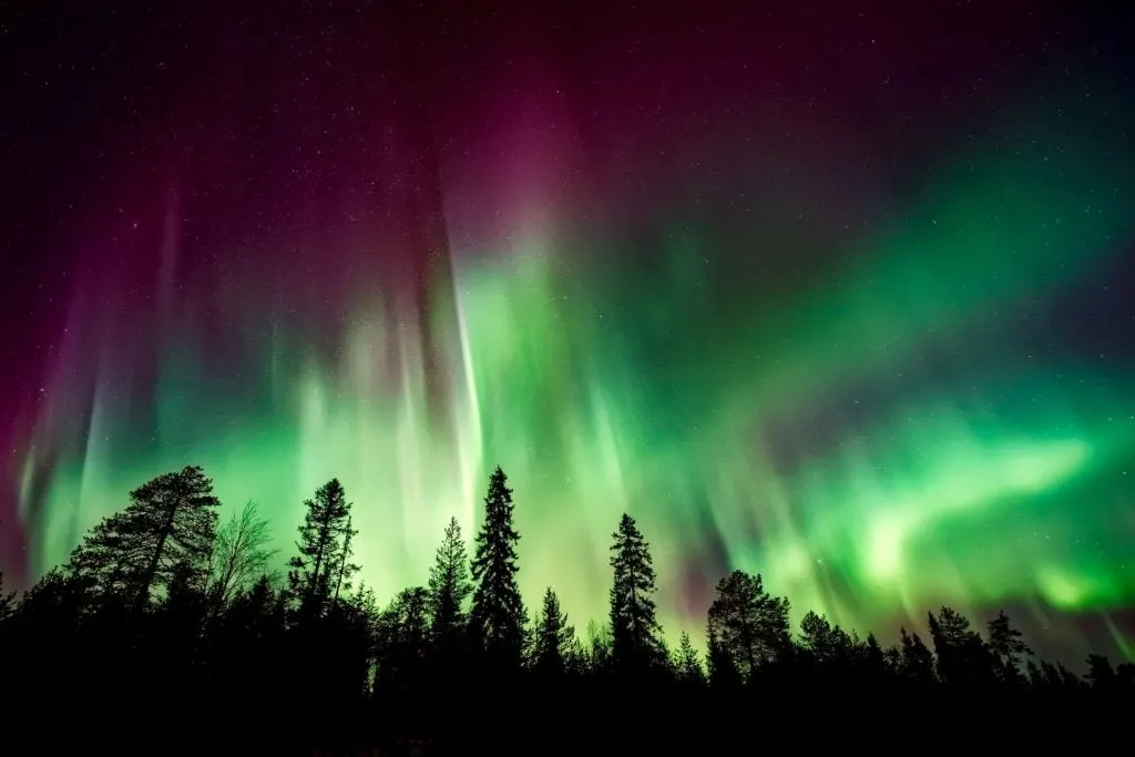 Northern lights over a snowy landscape